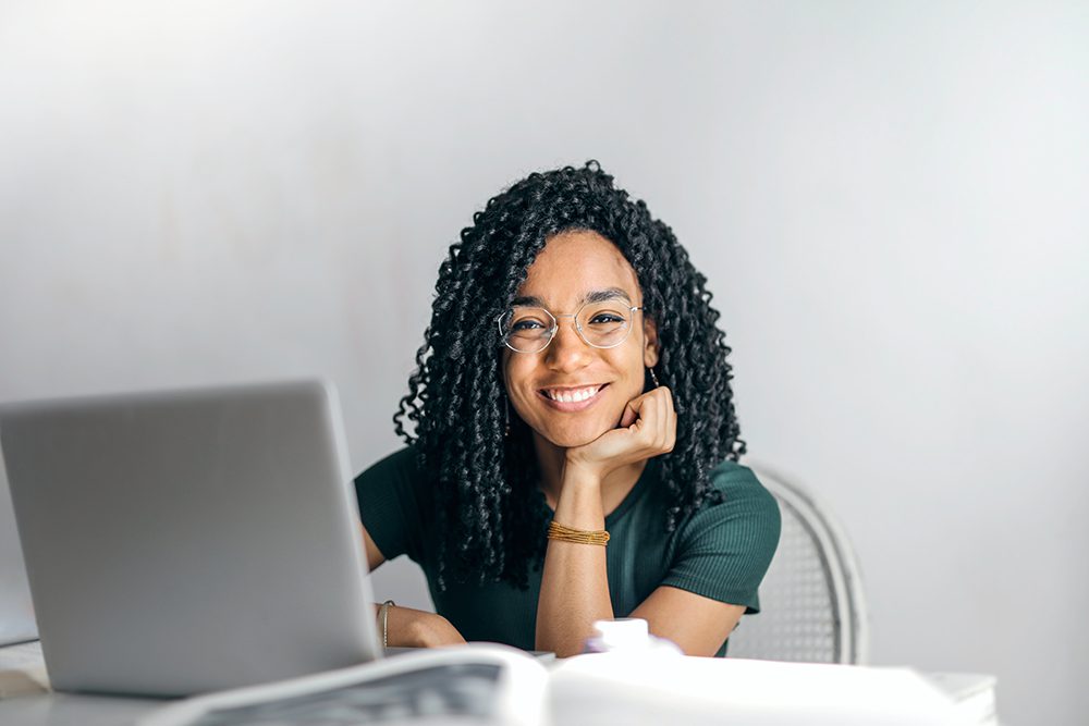 happy woman with laptop smiling
